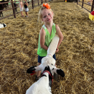 Prairie Raised Beef Summer Camp Farm Camp Sauk City, Wisconsin girl feeding a bottle calf